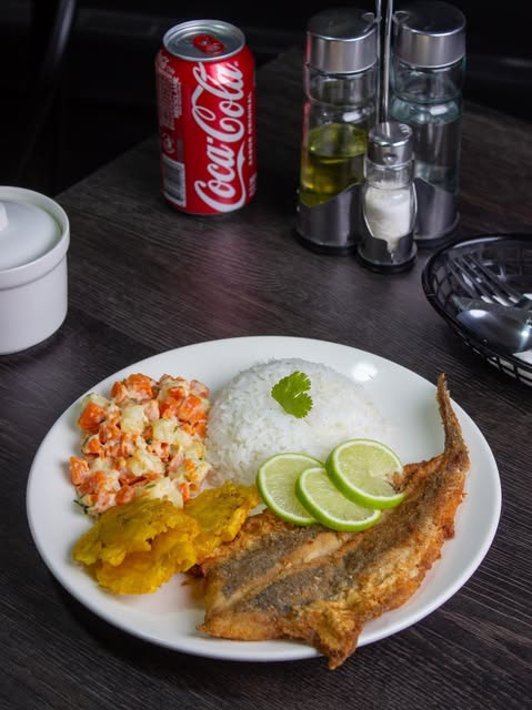 Pescado frito con arroz, tostones y ensalada